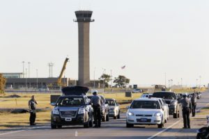 Oklahoma City police officers gather information from vehicles leaving Will Rogers World Airport, Tuesday Nov. 15, 2016, in Oklahoma City. The airport was put on lockdown after a shooting in the main terminal.