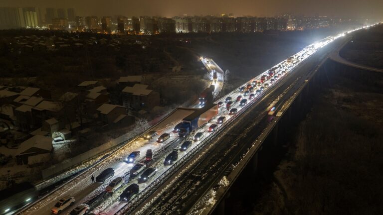 Thousands of vehicles stuck on highways in China as snow snarls Lunar New Year travel